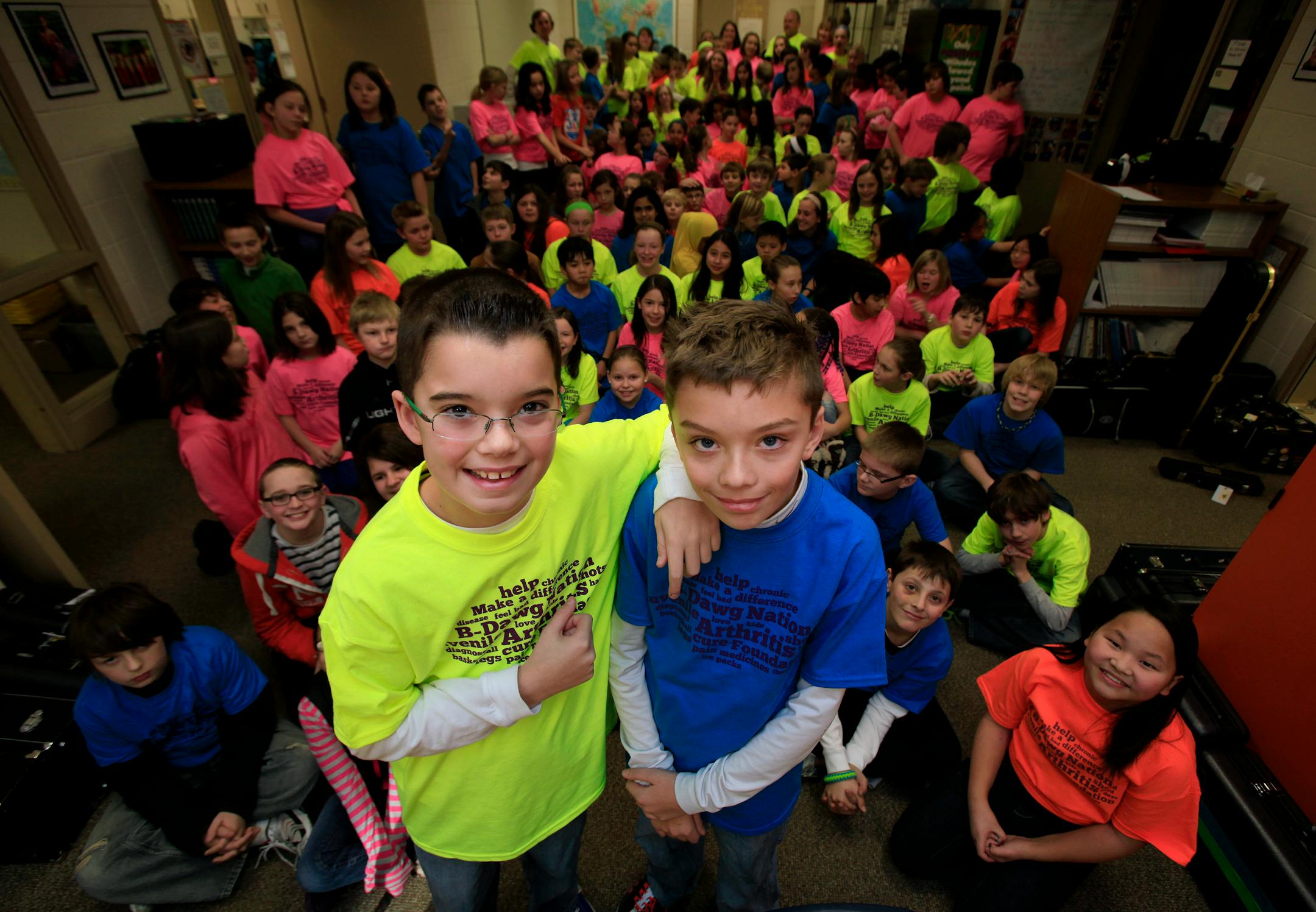 Jarrett Michie, 10, (left) with his twin brother Jack Michie (right) posed for a photo along with the other 5th grade students at Diamond Path School in Apple Valley, MN on January 23, 2013.