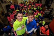 Jarrett Michie, 10, (left) with his twin brother Jack Michie (right) posed for a photo along with the other 5th grade students at Diamond Path School 
