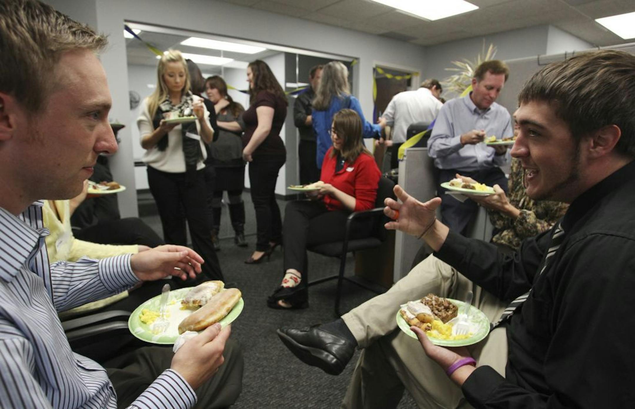 Co-workers Andy Boisjolie, left, and Alex Peterson chatted during a fika break at Employer Solutions Group in Edina.