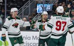 Wild forward Mats Zuccarello, center, is congratulated by Jon Merrill, left, and Kirill Kaprizov for his goal during the first period Friday in Seattl