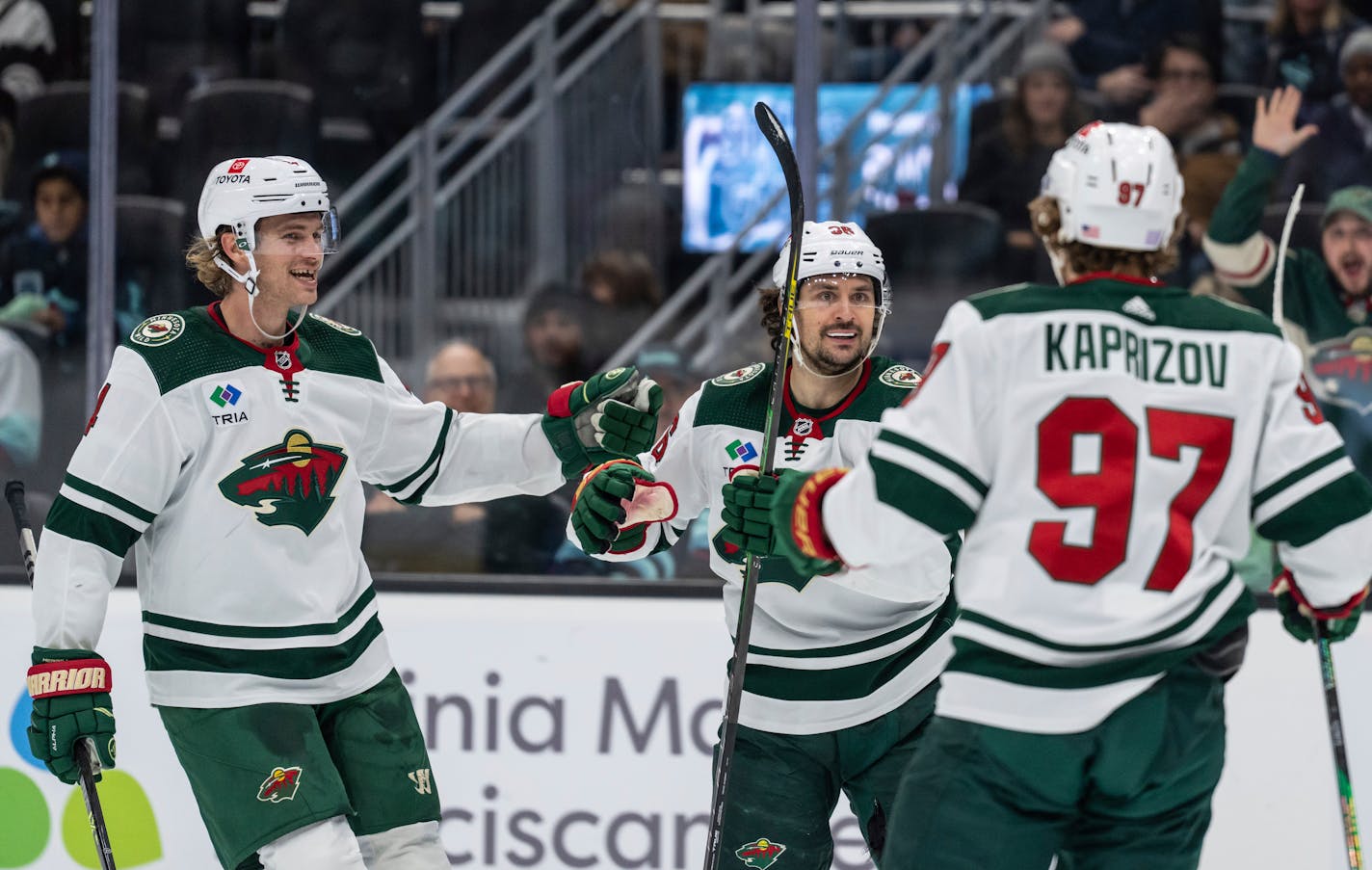 Wild forward Mats Zuccarello, center, is congratulated by Jon Merrill, left, and Kirill Kaprizov for his goal during the first period Friday in Seattle.