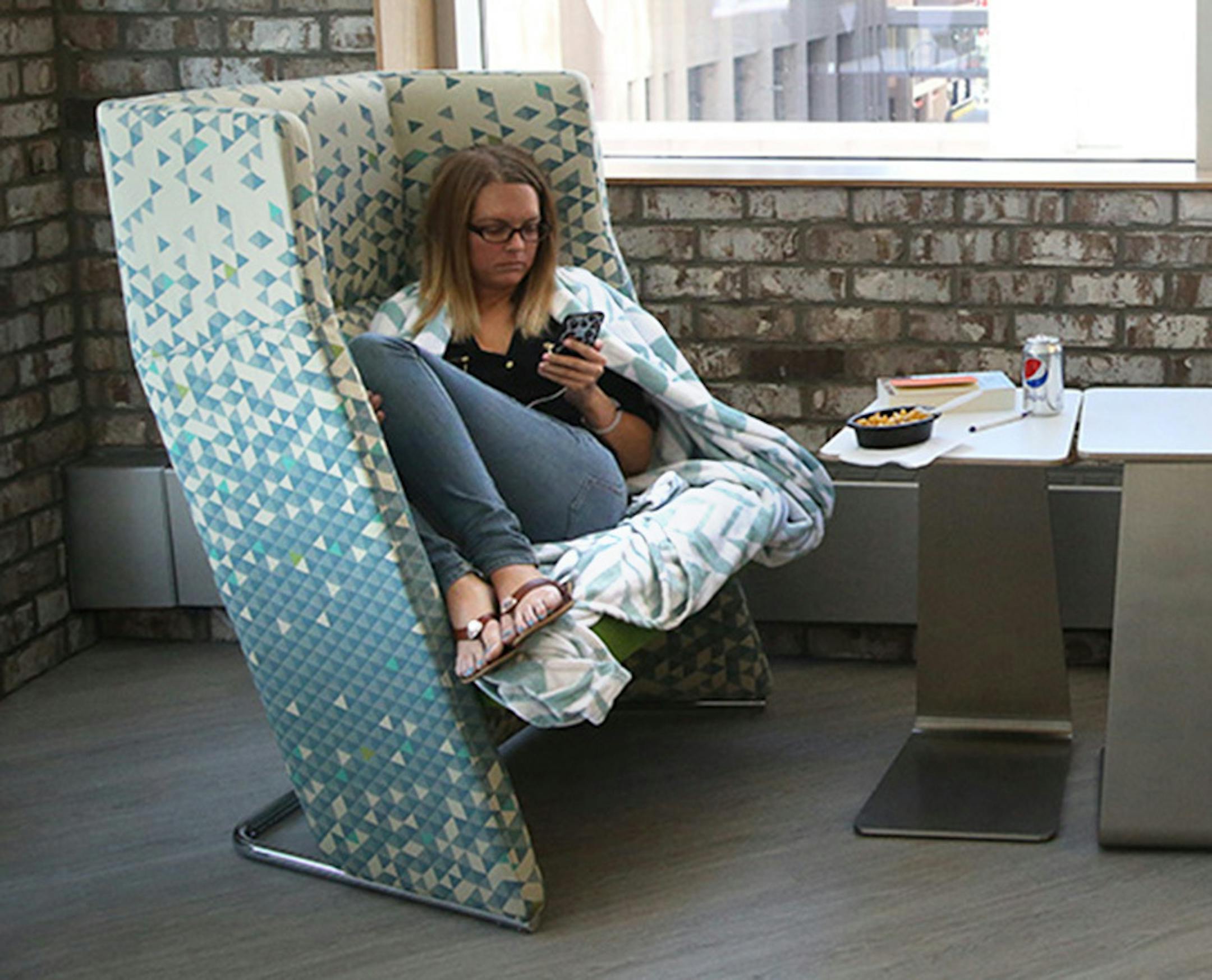Kelly Porter, library assistant, got cozy while taking her lunch break in one of the eating areas on the newly redesigned fourth floor.