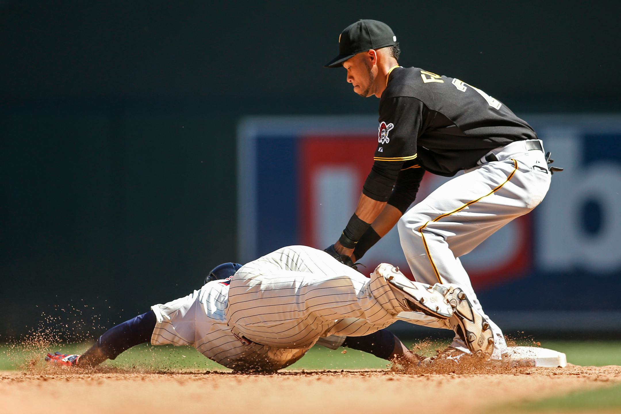 Pittsburgh Pirates shortstop Pedro Florimon, right, tags out Minnesota Twins designated hitter Miguel Sano, left, after Sano hit a double in the ninth inning to end a baseball game Wednesday, July 29, 2015, in Minneapolis. The Pirates won 10-4. (AP Photo/Bruce Kluckhohn)