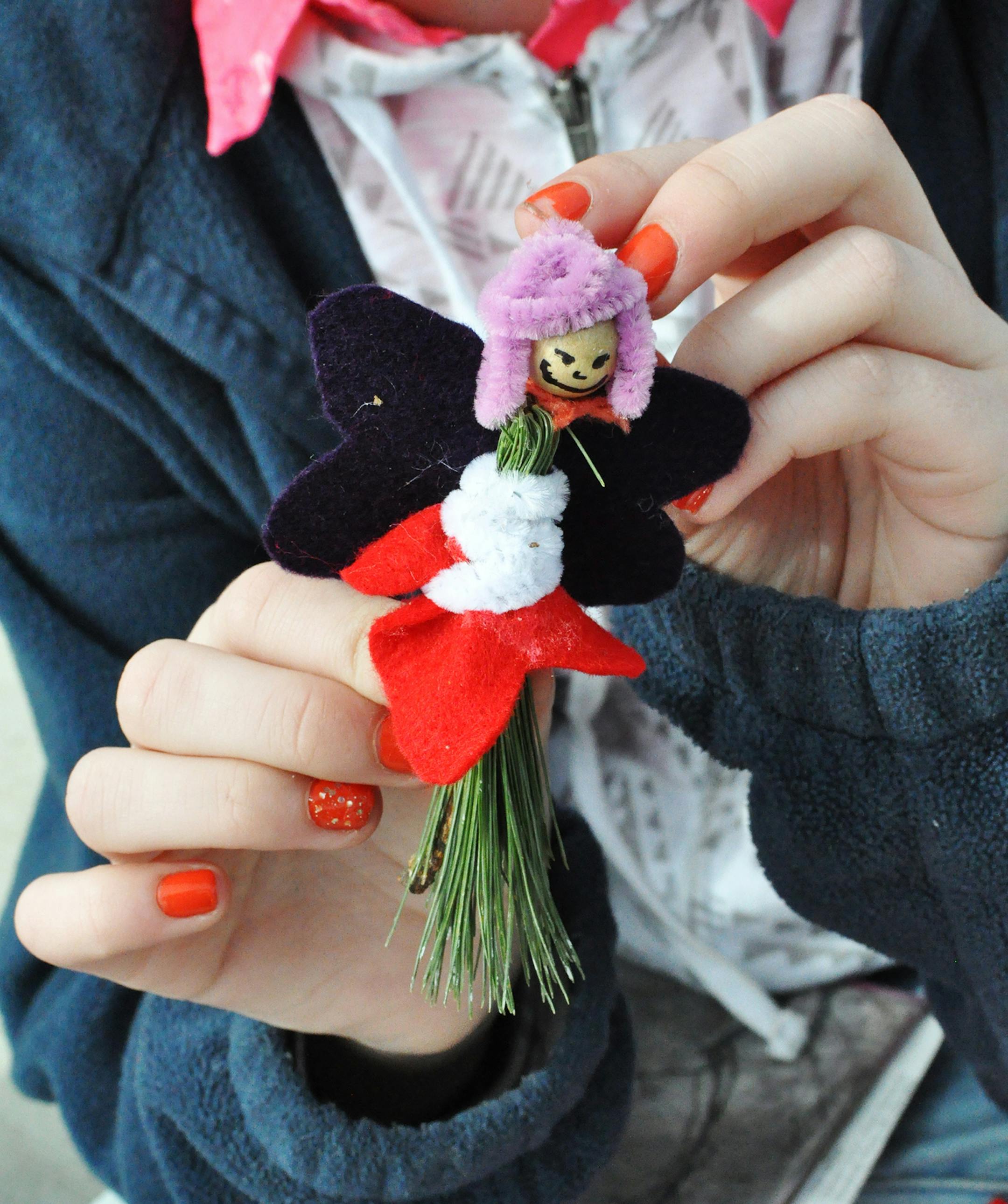 Eva Brock, 13, of South St. Paul, held up a fairy she made during an event at Fawn Crossing, a new nature play area at Whitetail Woods Regional Park. Photo by Liz Rolfsmeier, Special to the Star Tribune