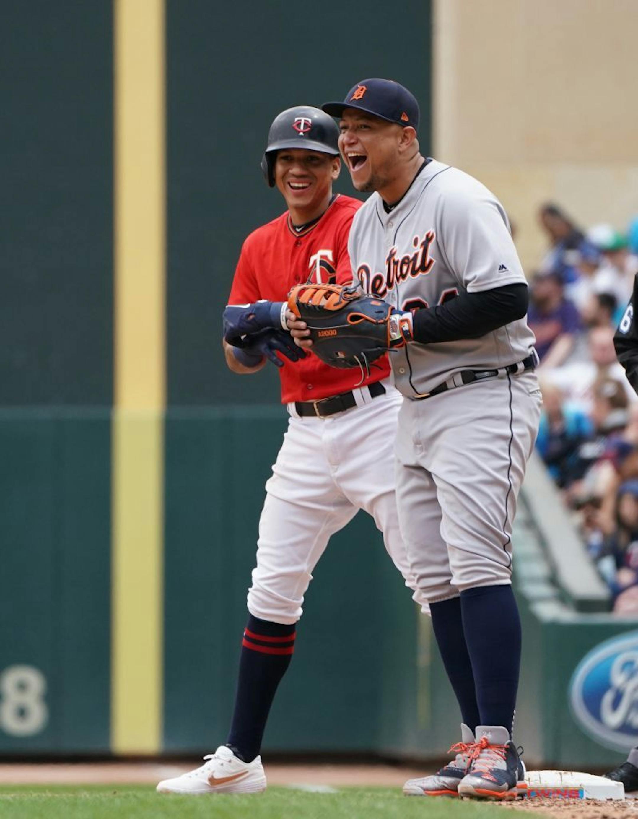 Minnesota Twins shortstop Ehire Adrianza (13) had a laugh with Detroit Tigers first baseman Miguel Cabrera (24) after Adrianza avoided a pick-off.
