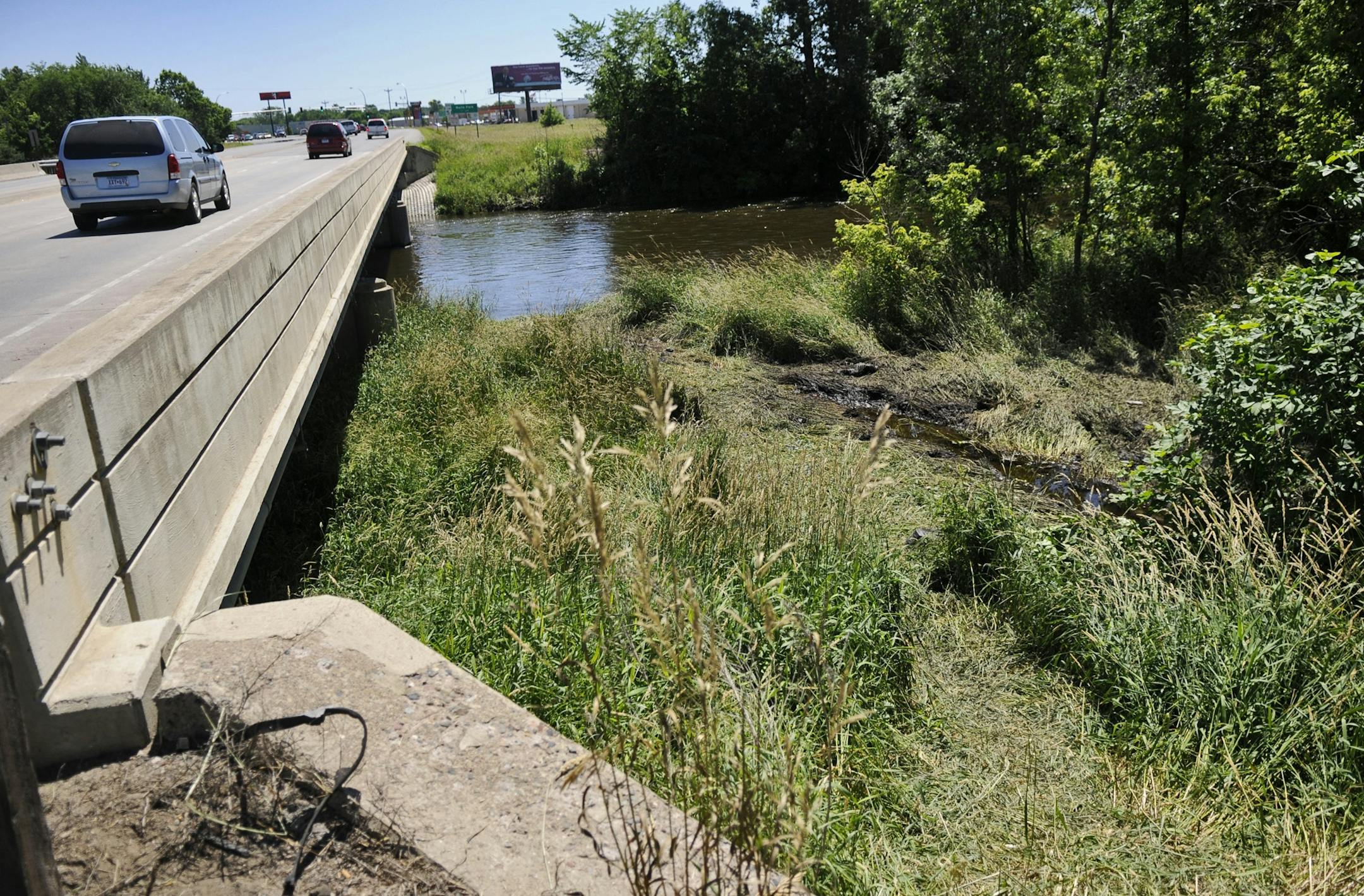 Cars pass by on a bridge over the Sauk River Monday, July 4, 2011 on Stearns County Road 75 near St. Cloud., where a man and two children died after the car they were riding in went off the road and landed upside-down in the river overnight. Two other men were treated at a hospital and released.