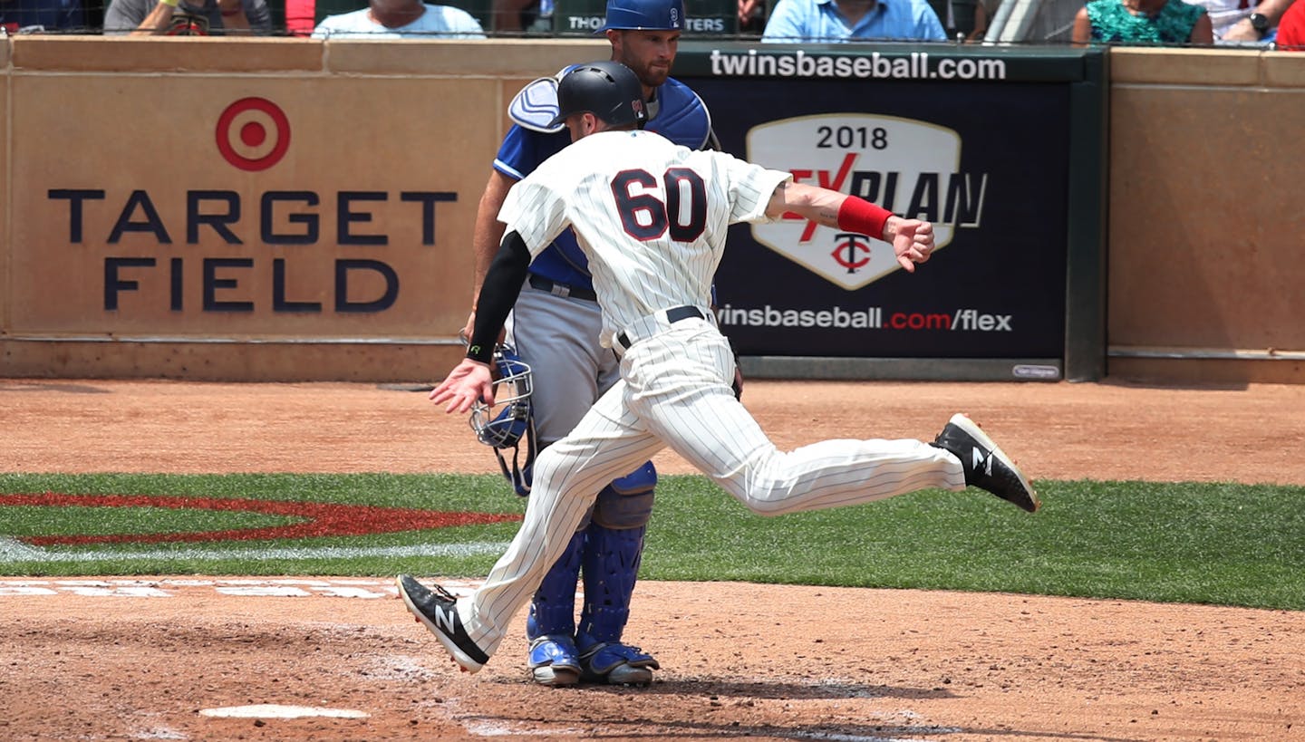 Minnesota Twins center fielder Jake Cave (60) scored on a two run single by Minnesota Twins second baseman Brian Dozier (2) in the fourth inning at Target Field Wednesday July 11, 2018 in Minneapolis , MN.