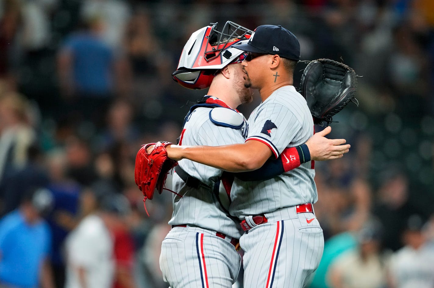 Minnesota Twins catcher Ryan Jeffers, left, hugs relief pitcher Jhoan Duran as they celebrate the team's 6-3 win over the Seattle Mariners in a baseball game Wednesday, July 19, 2023, in Seattle. (AP Photo/Lindsey Wasson)