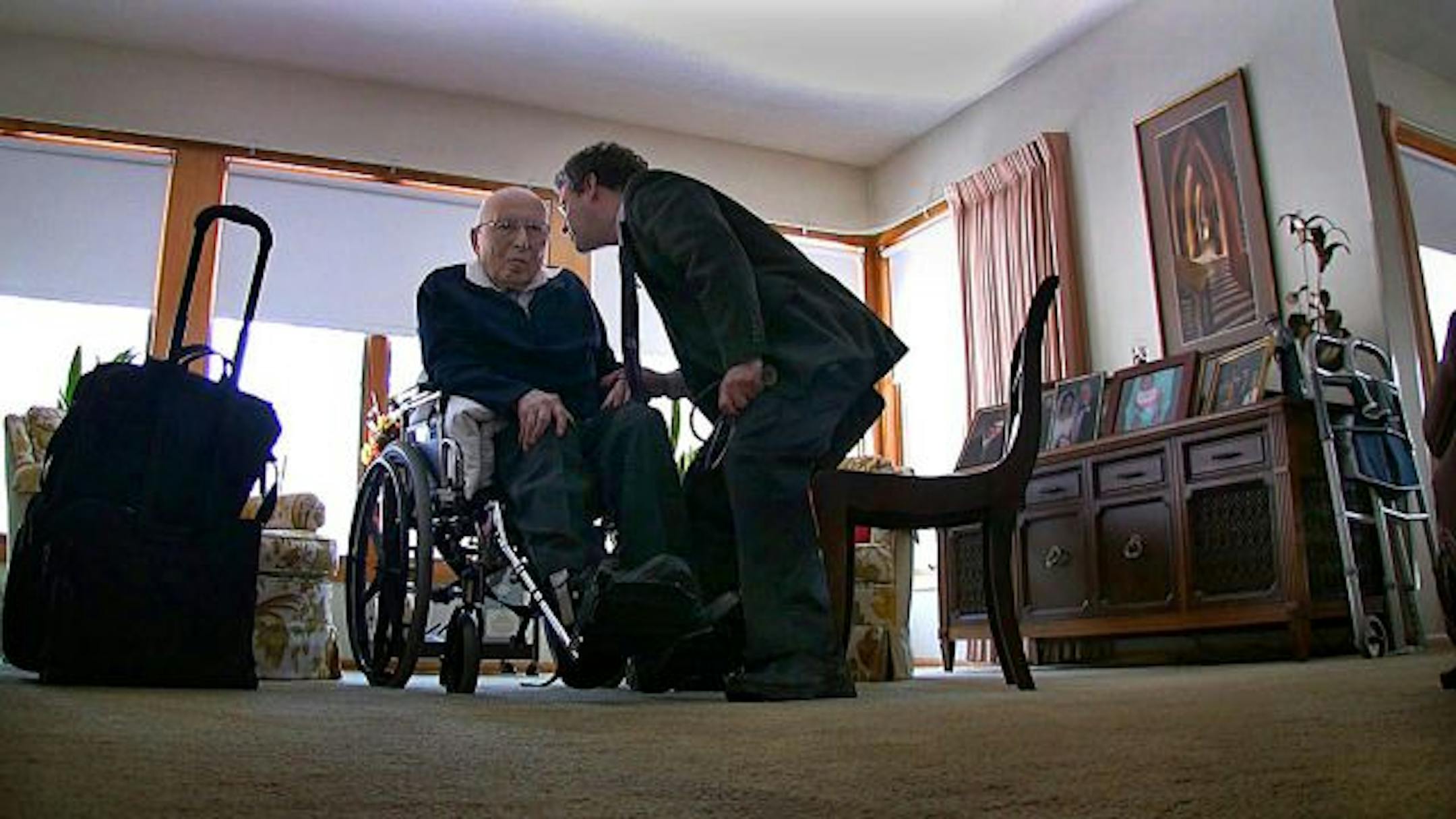 Dr. Edward Ratner talked with ninety-year-old Joseph Brochin during a house call to Brochin's home in Golden Valley. Ratner, an associate professor at the University of Minnesota Medical School who specializes in geriatric medicine, makes numerous house calls to frail, elderly patients.