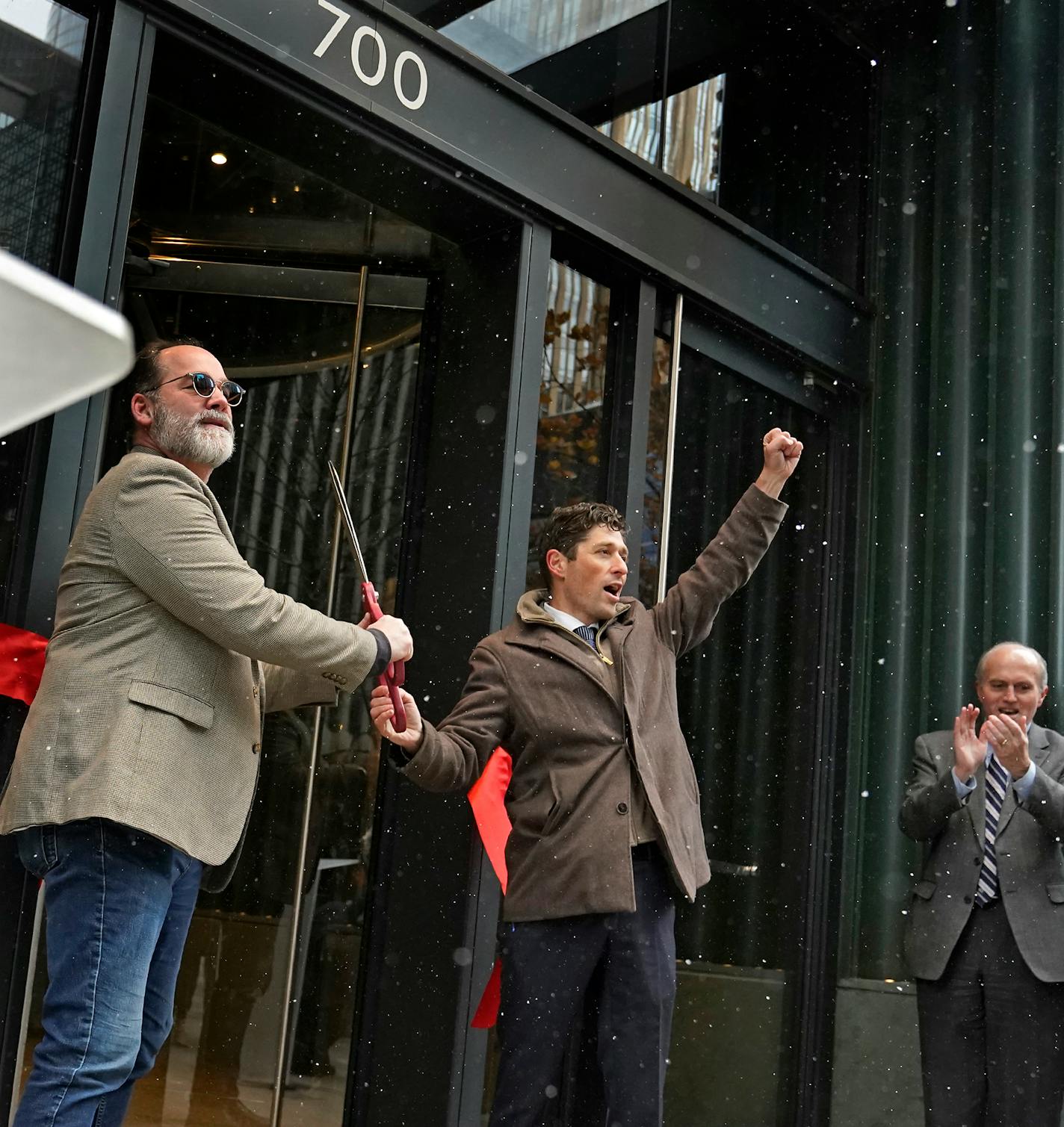 Don Kohlenberger, left, and Minneapolis mayor Jacob Frey, celebrate after cutting the ribbon for the Dayton's Project Thursday, Nov. 18, 2021 in Minneapolis, Minn. Looking on is Steven Cramer, right, president and CEO, MPLS Downtown Council.] DAVID JOLES • david.joles@startribune.com