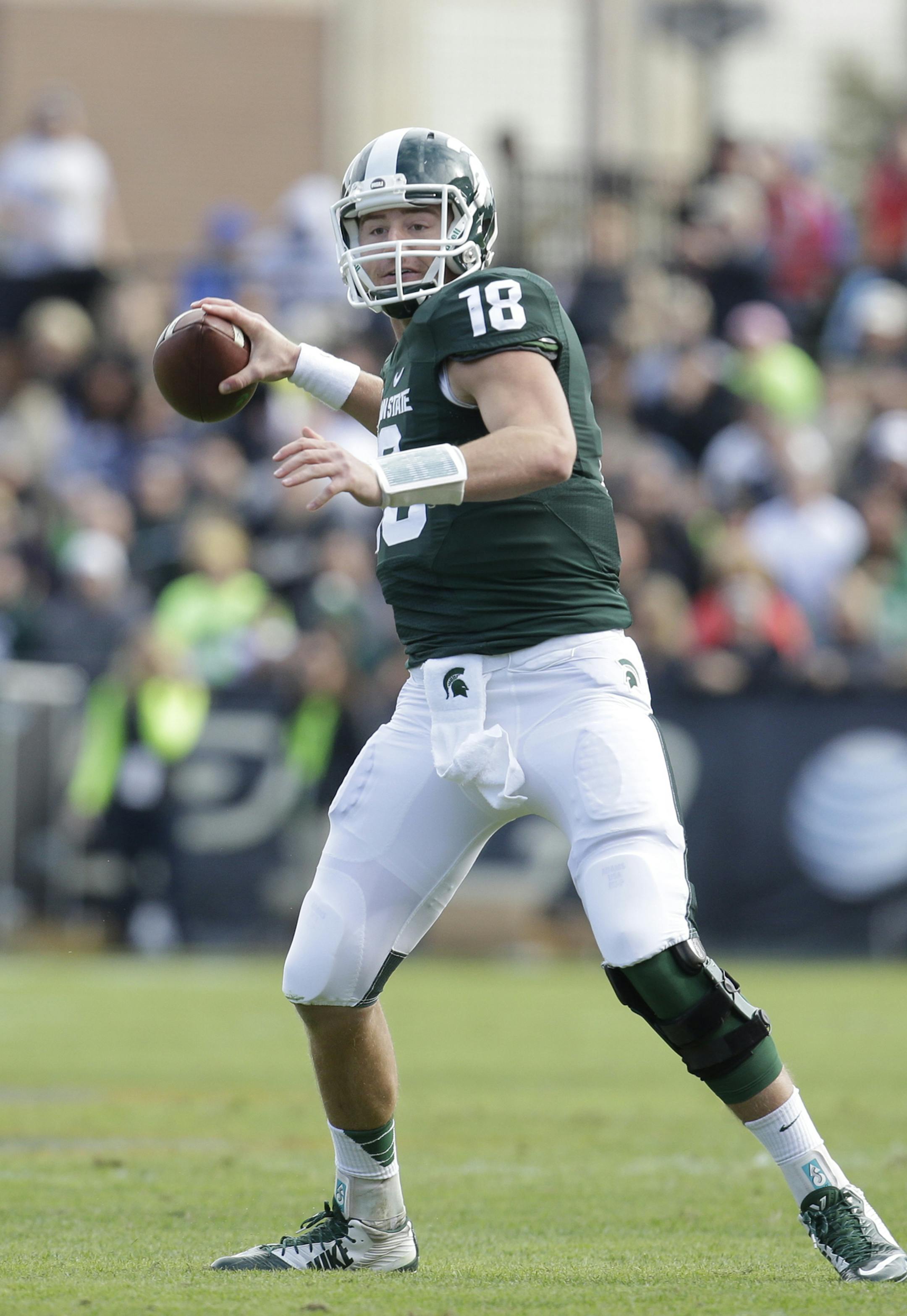 Michigan State quarterback Connor Cook (18) as Michigan State played Purdue in an NCAA college football game in West Lafayette, Ind., Saturday, Oct. 11, 2014. Michigan State won 45-31. (AP Photo/AJ Mast) ORG XMIT: OTKINAM248