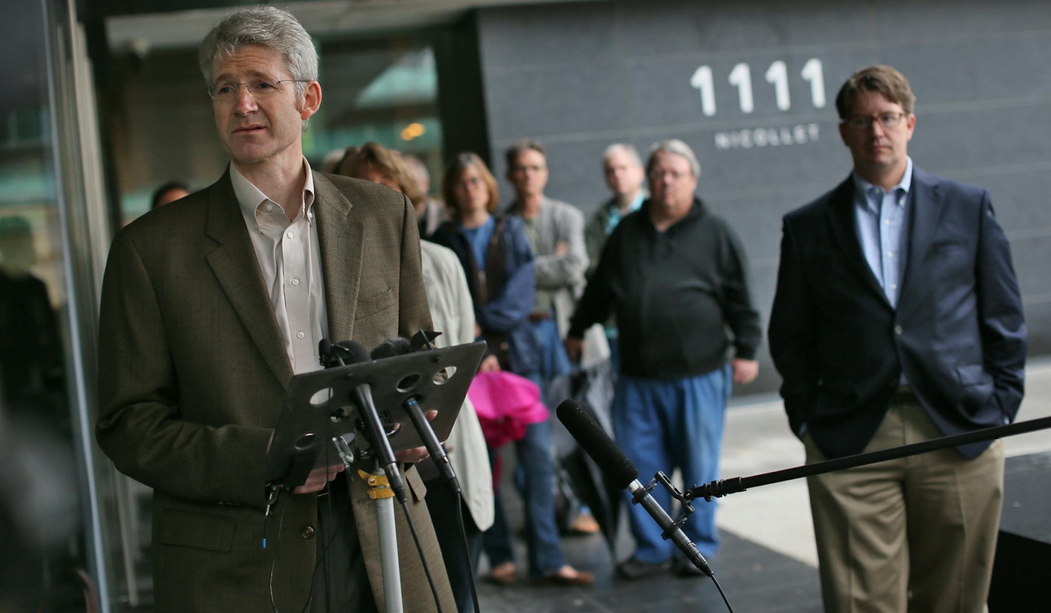 Kevin Watkins takes his turn answering questions at the Saturday morning press conference. right, Spokesman Blois Olson. Minnesota Orchestra musicians voted unanimously Saturday, 60-0, against an offer from management.