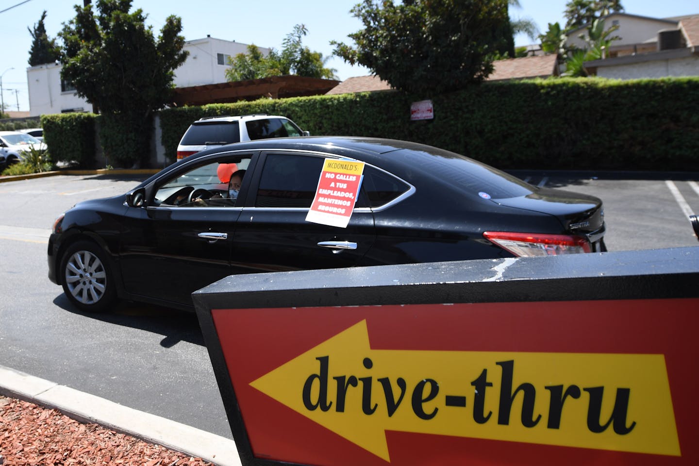 McDonald's workers and their supporters hold a drive-thru rally to protest what they allege is McDonald's attempts to silence a worker who spoke out about unsafe conditions amid the COVID-19 pandemic, Aug. 7, 2020, outside a McDonald's in Los Angeles. (Robyn Beck/AFP/Getty Images/TNS)