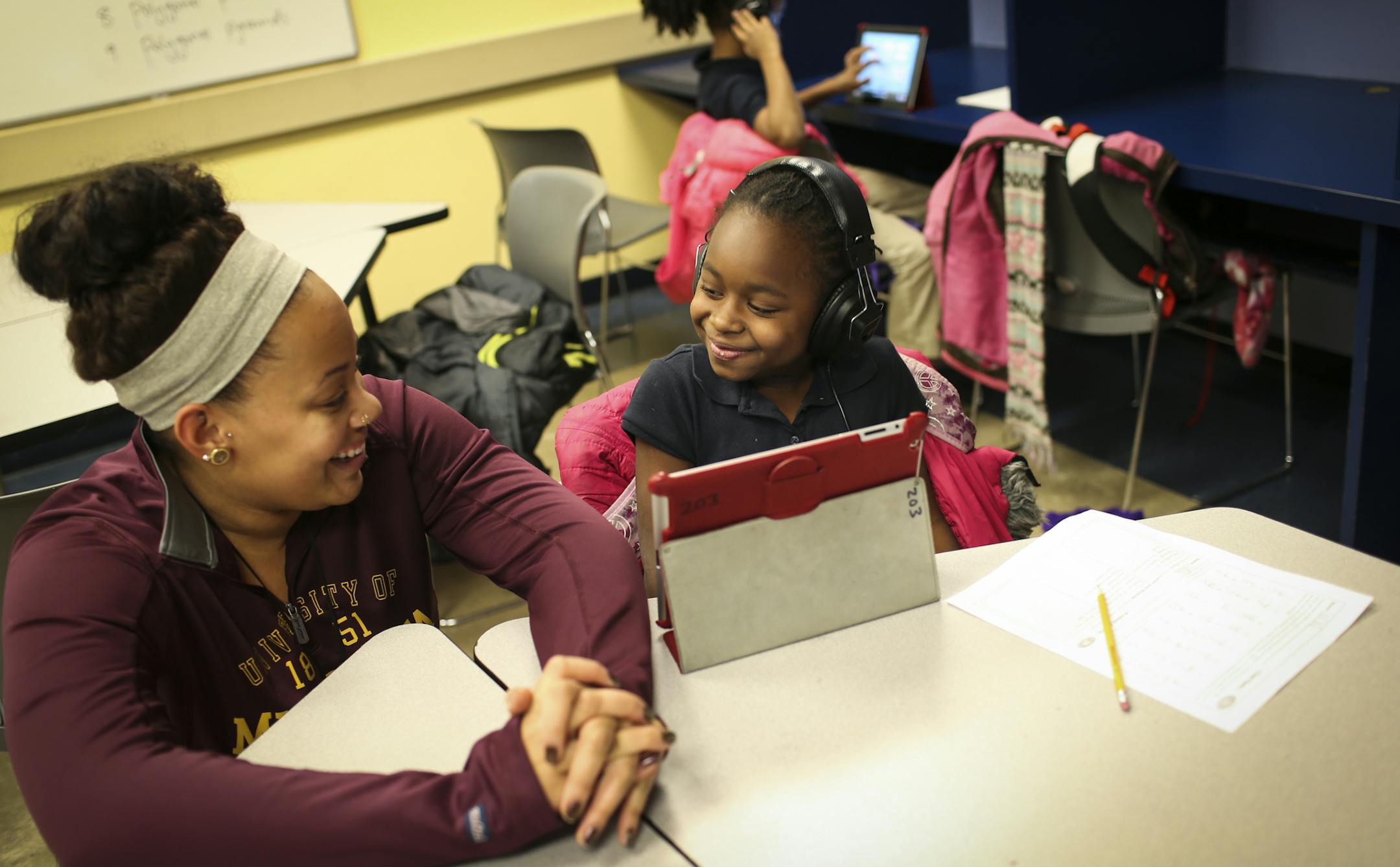 Instructor Vanessa Gill helped out student Sarai Roberts, 7, with a Lexia reading and writing iPad program during a Northside Achievement Zone after-school program at Plymouth Christian Youth Center on Tuesday, December 9, 2014. ] RENÉE JONES SCHNEIDER reneejones@startribune.com