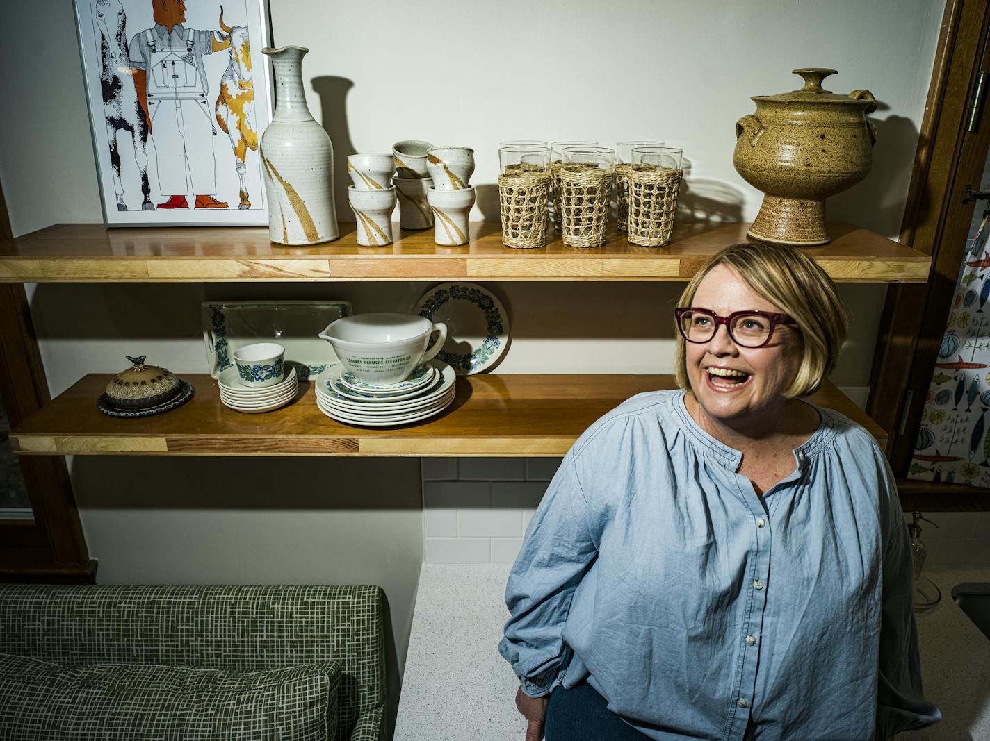 Designer Liz Knutson turned a discarded door into open shelving in her kitchen, where she displays favorite objects. "That's what a home is — stuff that makes you smile," she said.