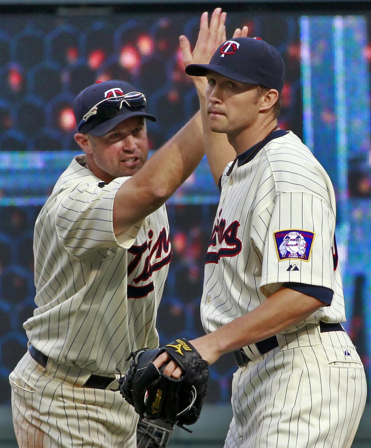 Michael Cuddyer, left, congratulated pitcher Scott Baker after Baker's complete game Saturday.