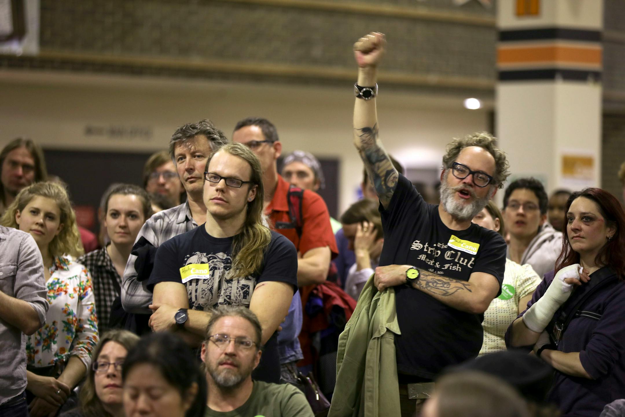 James Christenson raised his fist in support of remarks by a candidate for the park board who spoke to the Ward 9, Precinct 2 gathering at South High School.