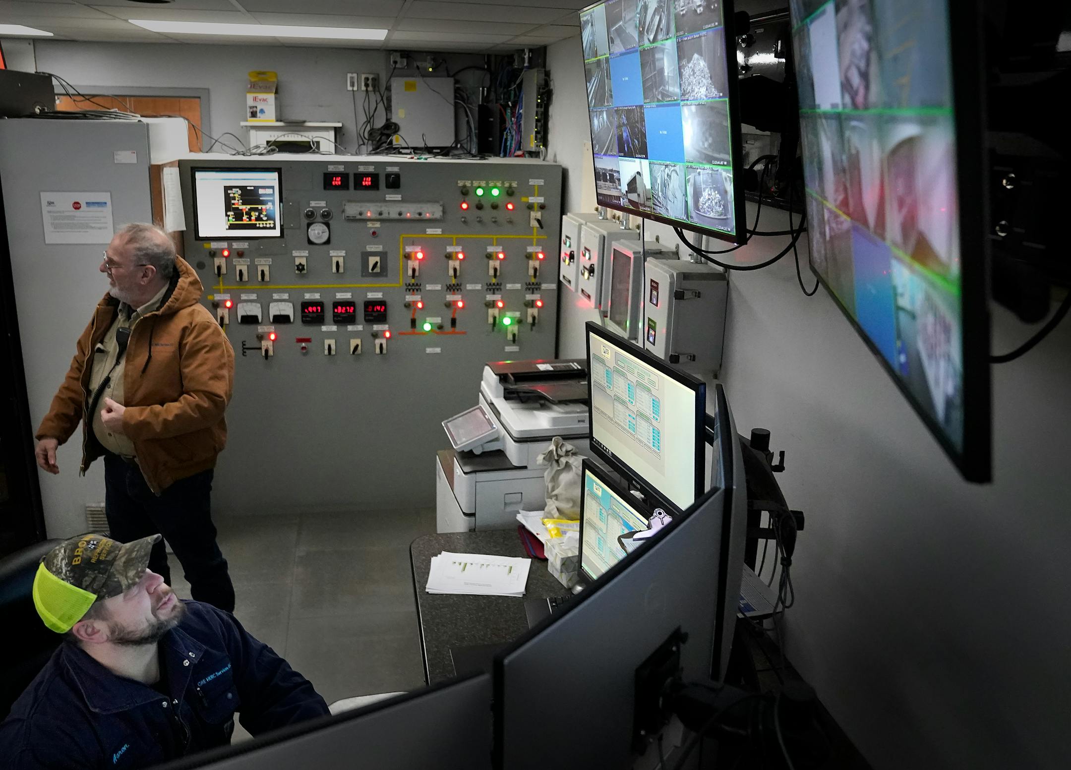 Hennepin Energy Recovery Center, or HERC, control room operator Aaron Branchaud monitors the operation as HERC environmental compliance manager Dan Fish looks on.