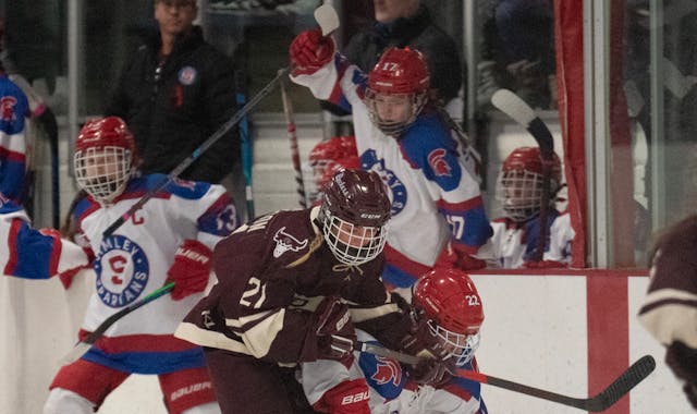 South St. Paul Packers forward Alyiah Danielson (21) earned a tripping penalty for a hit on Simley Spartans defenseman Courtney Kurowski (22) in the f