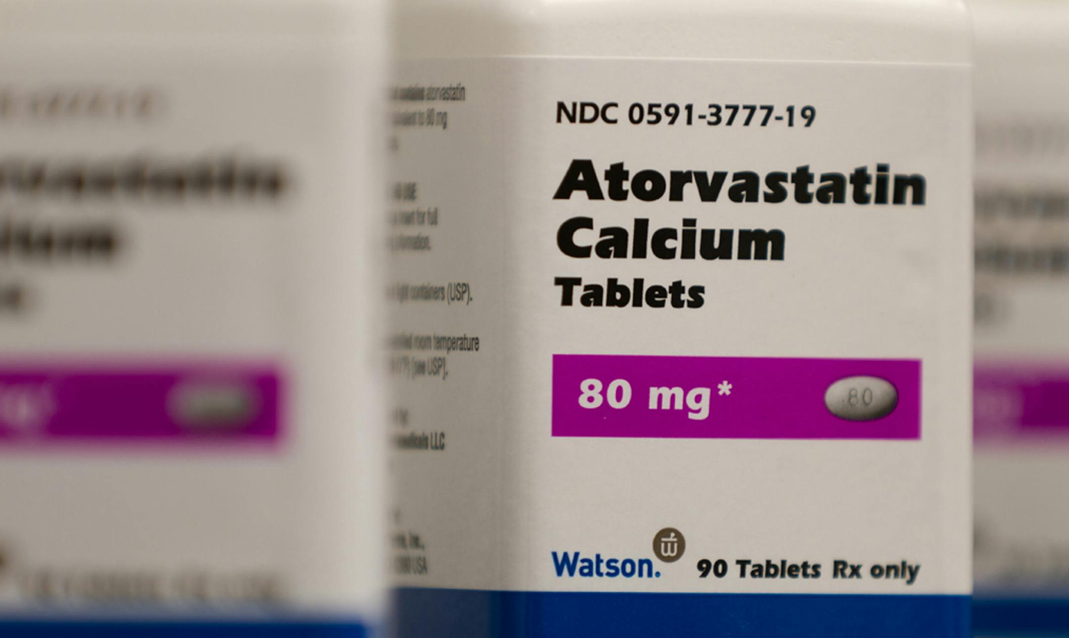 FILE - This 2011 photo provided by Watson Pharmaceuticals Inc. shows bottles of Atorvastatin Calcium tablets, a generic form of Lipitor which is sold under a deal with Pfizer. Half of Americans ages 40 to 75 and nearly all men over 60 qualify to consider cholesterol-lowering statin drugs under heart disease prevention guidelines issued in November 2013, a new analysis concludes. It was published online Wednesday, March 19, 2014 by the New England Journal of Medicine. (AP Photo/Watson Pharmaceuti