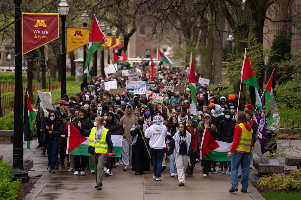 Demonstrators marched on the Northrop Mall before setting up tents on the lawn Monday afternoon on the University of Minnesota campus in Minneapolis. 