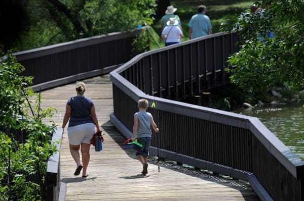 Silverwood Park is the latest park in the Three Rivers Park district to open. Christine Okerstrom of Fridley walks with her 8-yr-old nephew Cross Oker