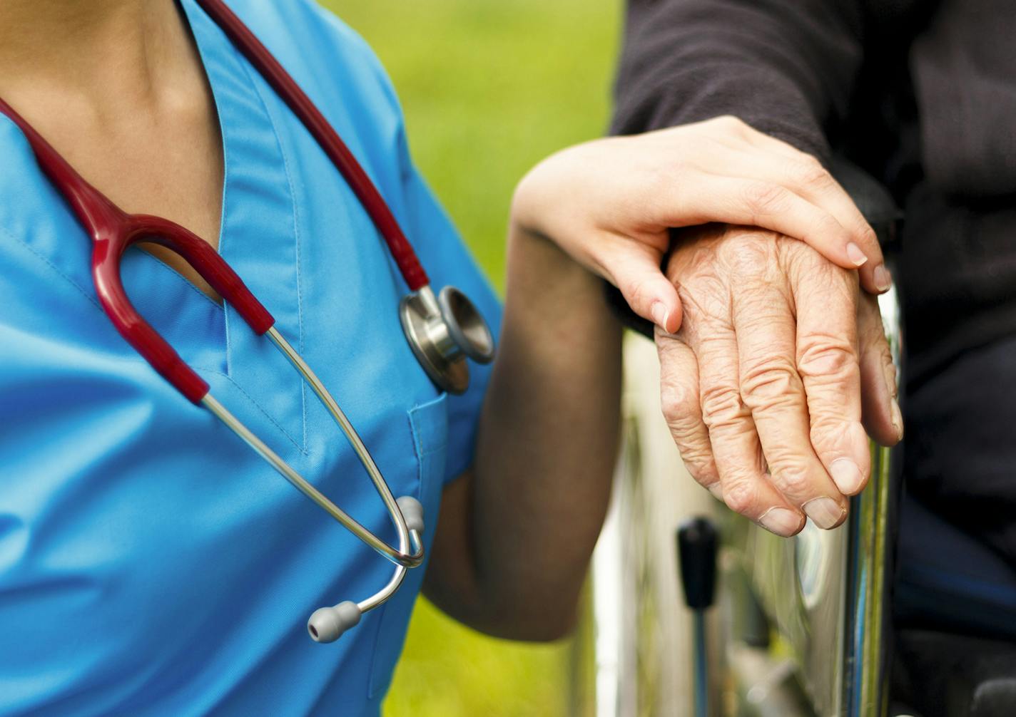 Nurse caring for elderly in nursing home.