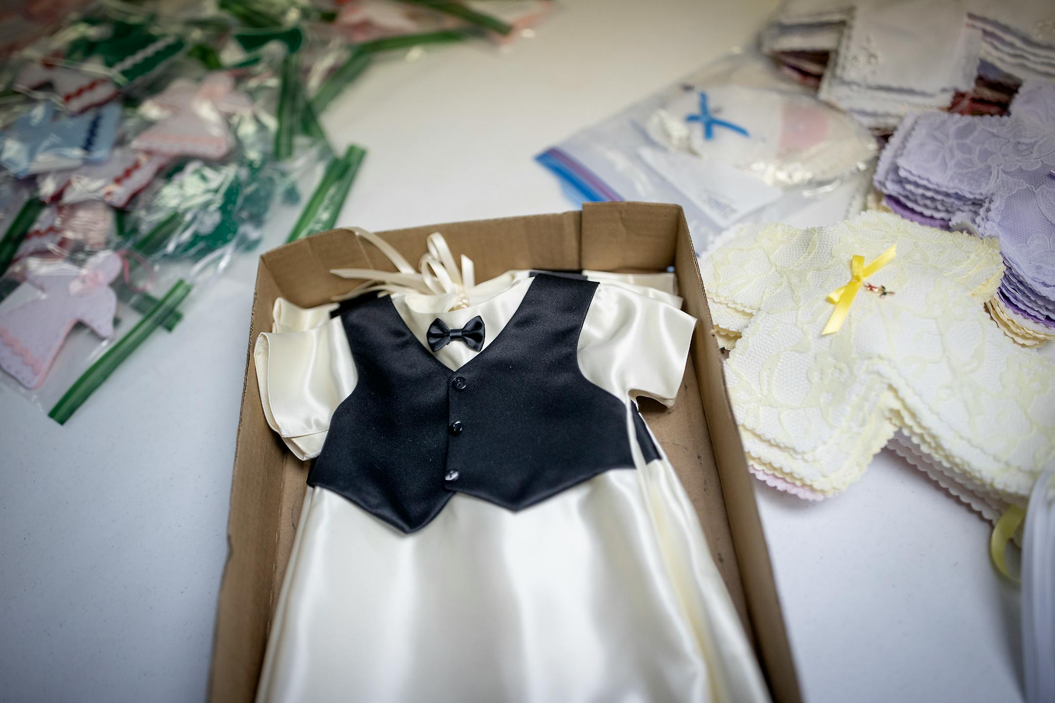 Patty Hauer's church group organize "Angel Dresses" and other items to be packaged for delivery in the All Saints Lutheran Church basement in  Darwin, Minn.
