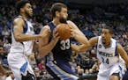 Minnesota Timberwolves center Karl-Anthony Towns, left, and guard Andre Miller (24) pressure Memphis Grizzlies center Marc Gasol (33), of Spain, durin