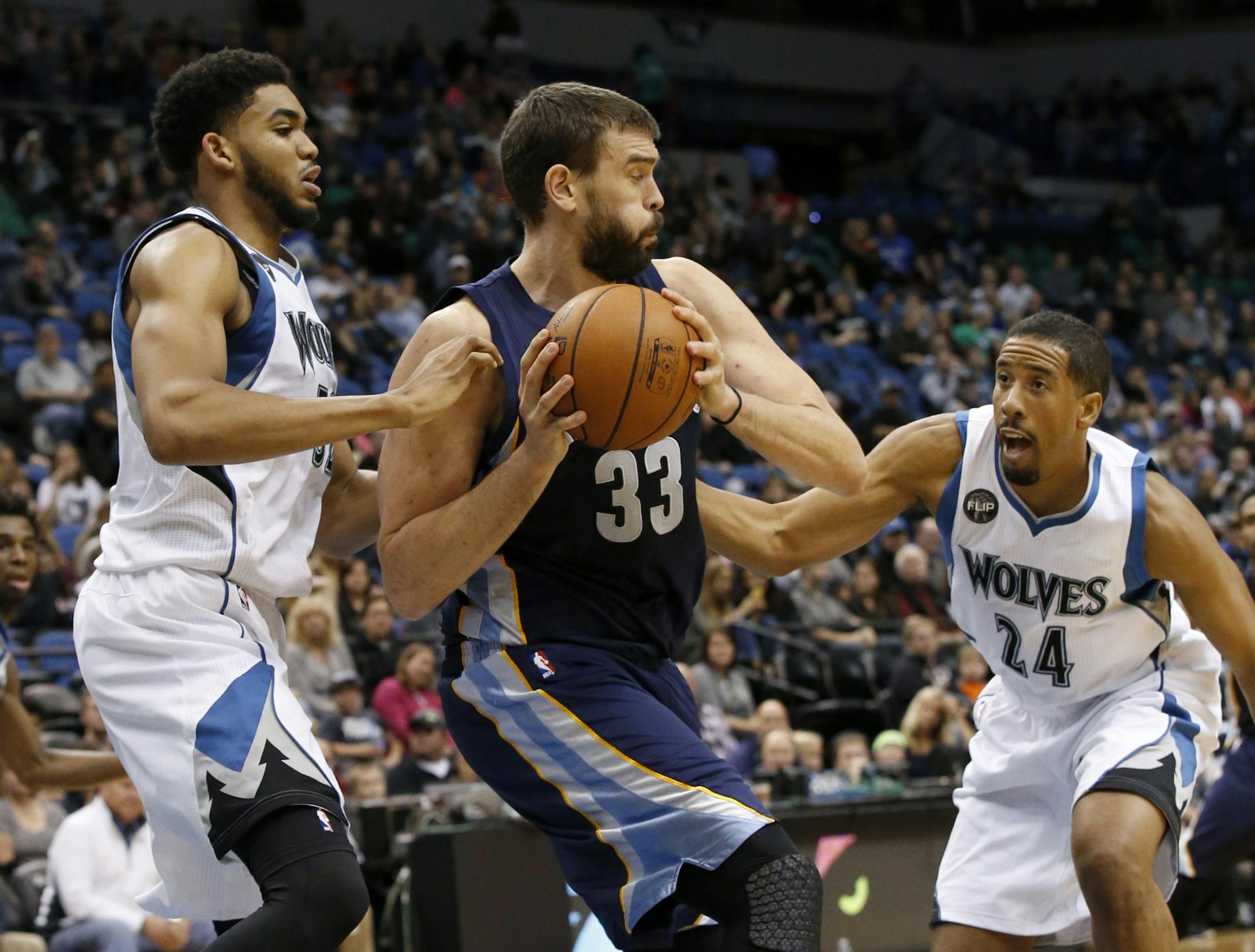 Minnesota Timberwolves center Karl-Anthony Towns, left, and guard Andre Miller (24) pressure Memphis Grizzlies center Marc Gasol (33), of Spain, during the second half of an NBA basketball game in Minneapolis, Sunday, Nov. 15, 2015. The Grizzlies won 114-106.