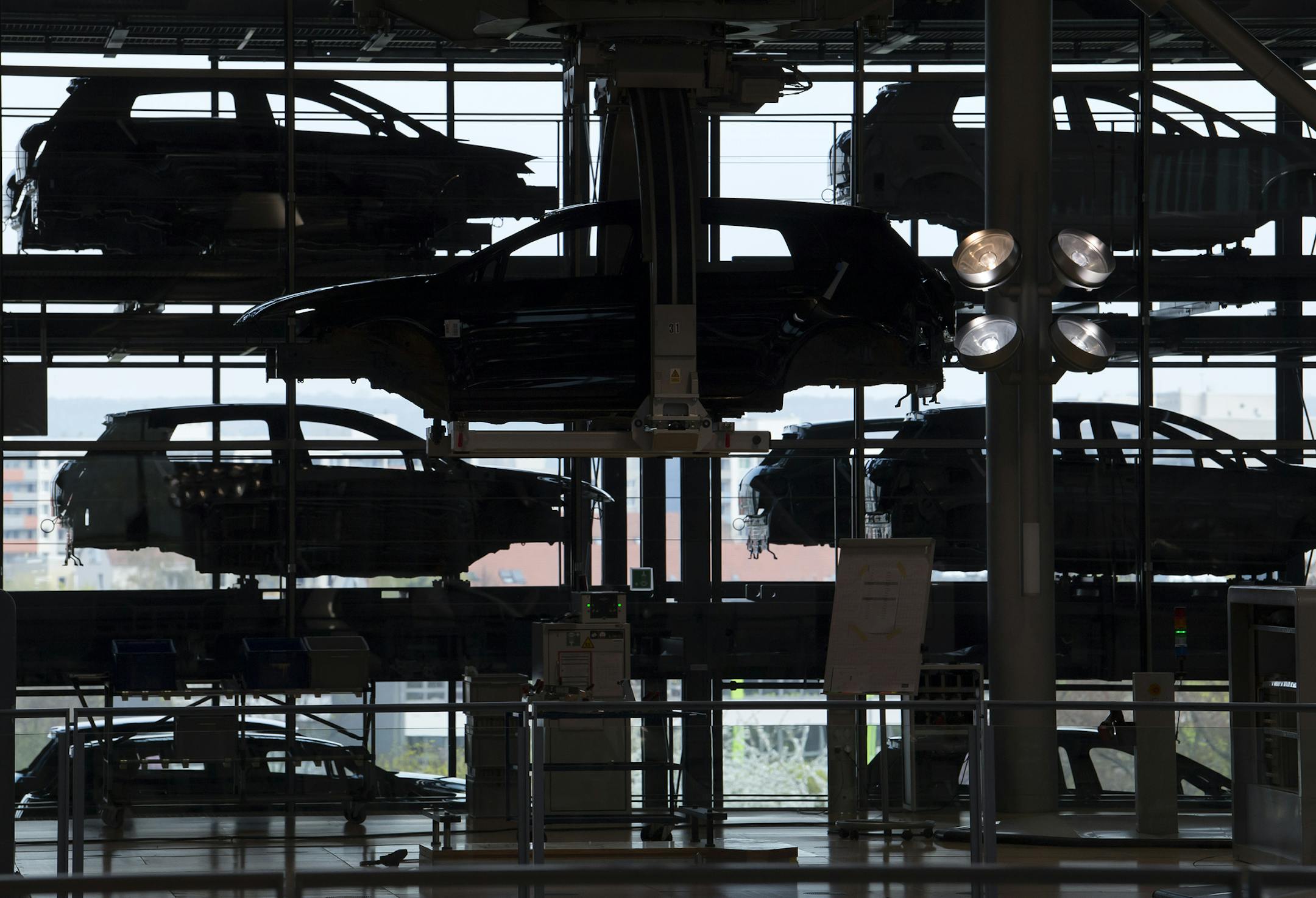 E-Golf electric cars hang in the assembly line during the official production start in the German car manufacturer Volkswagen Transparent Factory (Glaeserne Manufaktur) in Dresden, eastern Germany, Monday, April 3, 2017. (AP Photo/Jens Meyer) ORG XMIT: JME110