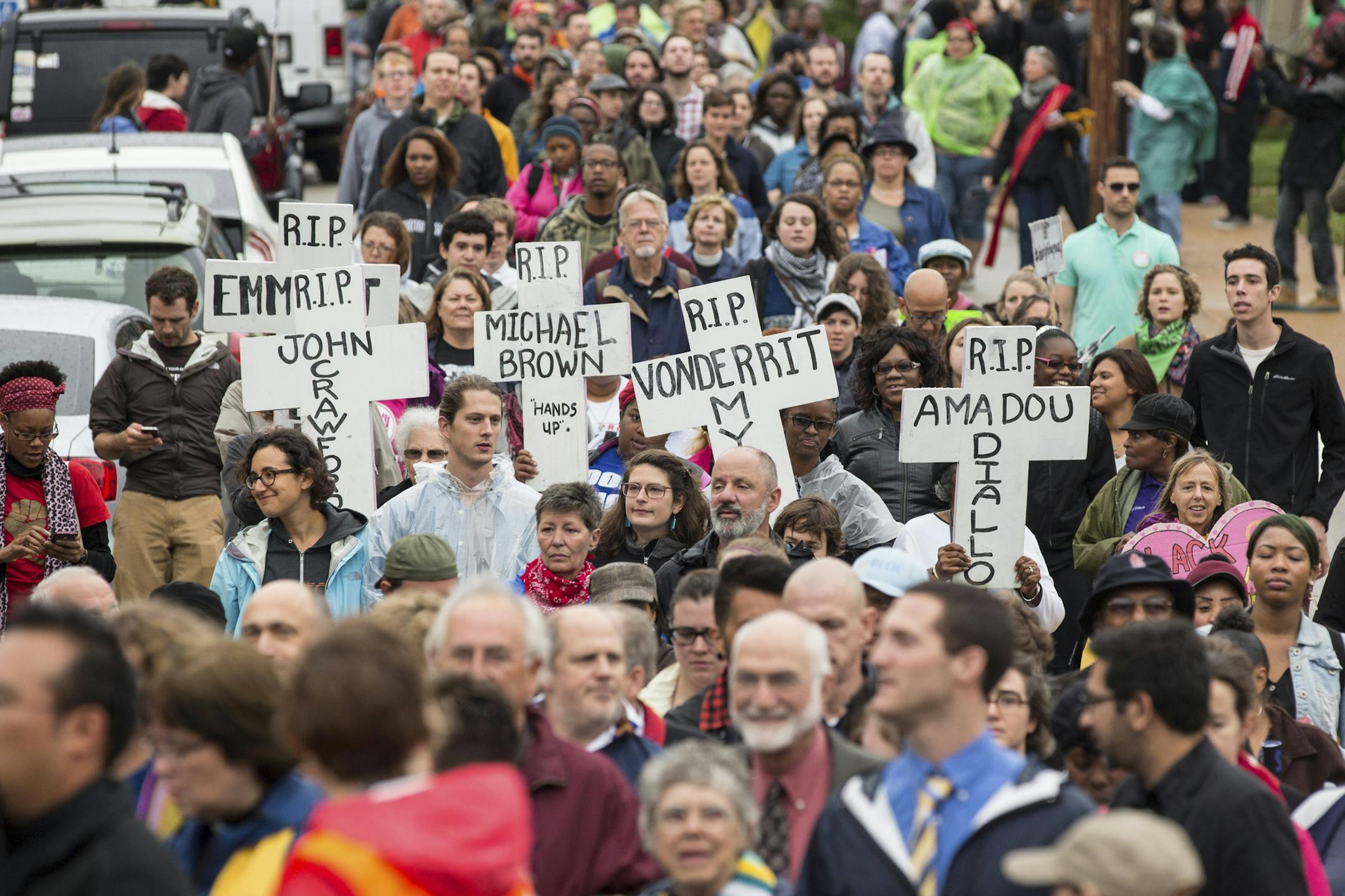 Demonstrators march to the police department in Ferguson, Mo., Oct. 13, 2014. Protesters were arrested on Monday as they stepped forward into a line of officers in riot gear outside the police department, a day when organizers here have promised numerous demonstrations of civil disobedience around the St. Louis region over questions about police conduct. (Whitney Curtis/The New York Times)