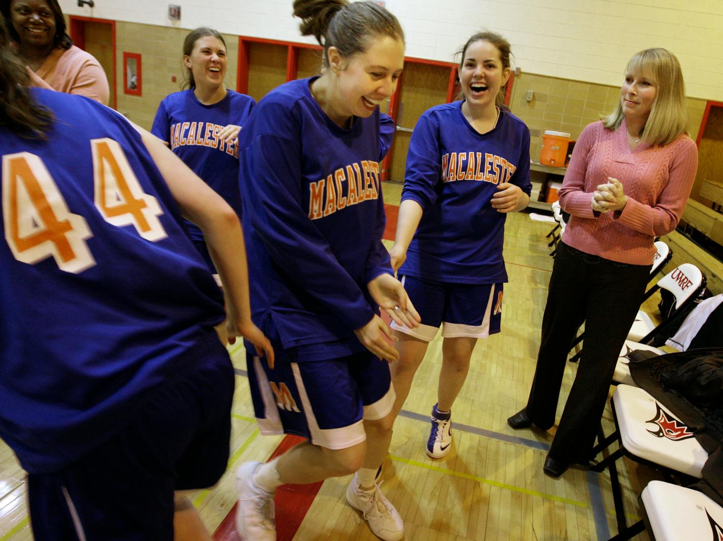 Richard Tsong-Taatarii/rtsong-taatarii@startribune.com
River Falls, MN;12/14/07;left to right: At UW River Falls, Macalester center Ann Baltzer(center) headed back to the bench as she realized that her teammate Alyssa Lunde's name was called instead. Head coach Ellen Thompson, far right, has helped turn the program around.