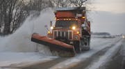 A DOT truck plowing snow on Hwy. 56 near Kenyon.