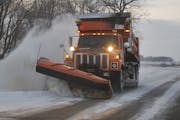 A DOT truck plowing snow on Hwy. 56 near Kenyon.