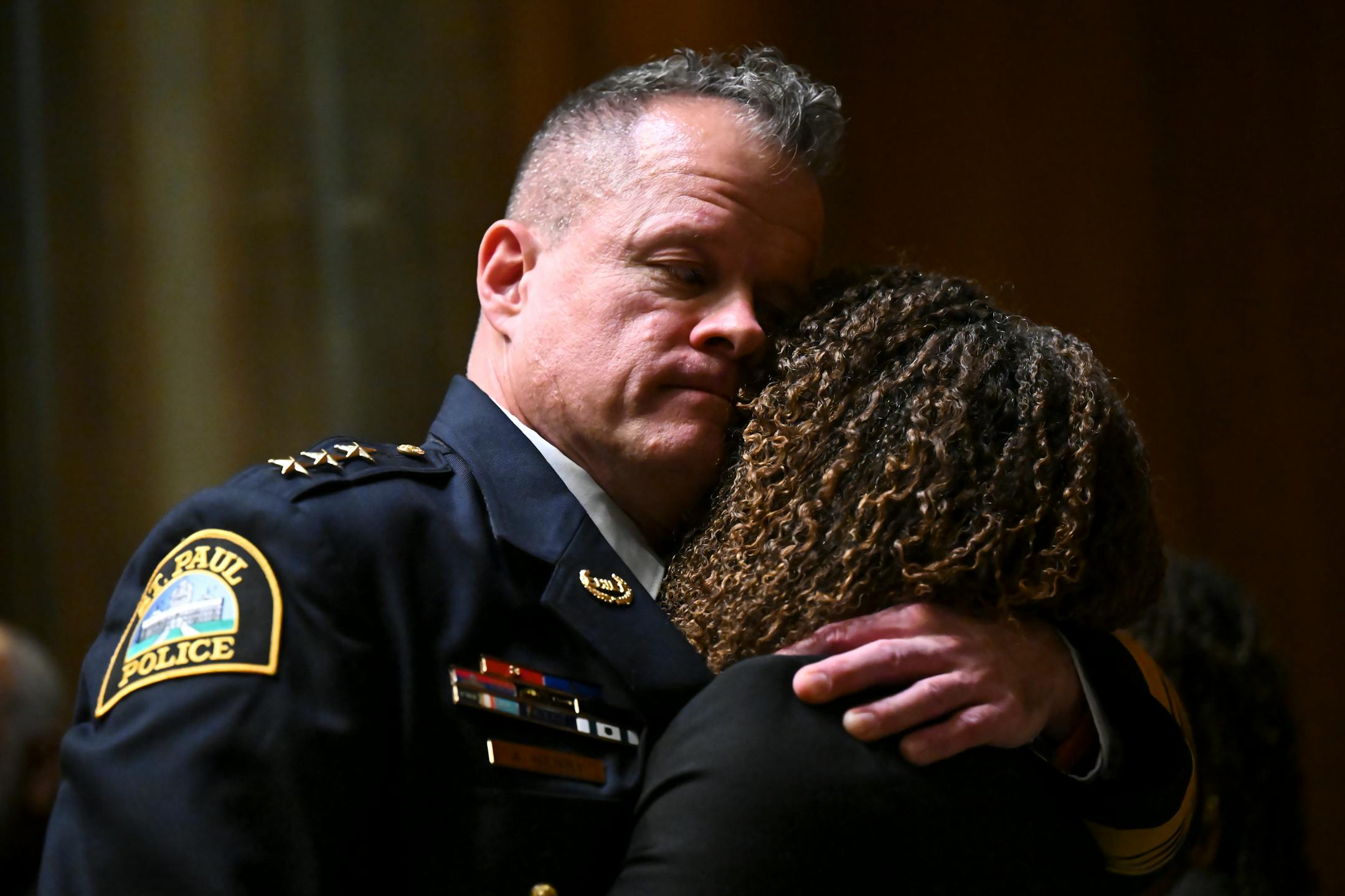 Newly sworn-in St. Paul Police Chief Axel Henry hugs his partner, Mikeya Griffin, after he was unanimously confirmed as chief Wednesday, Nov. 16, 2022 at St. Paul City Hall in St. Paul, Minn..