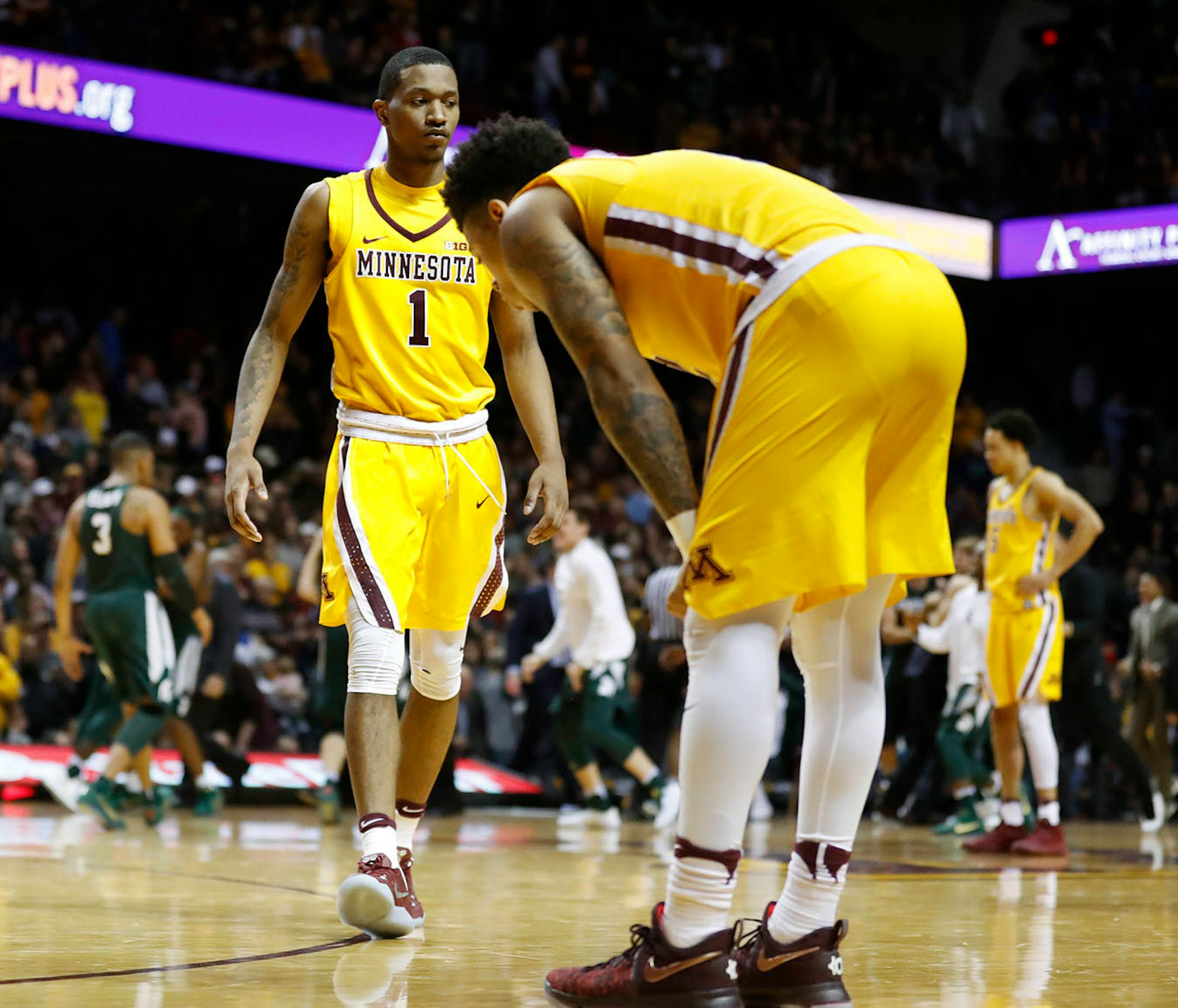 Minnesota Golden Gophers guard Dupree McBrayer (1) walked toward teammate guard Nate Mason (2) right as he dropped his head after missing the winning shot giving MSU a 75-74 overtime win at Williams Arena Tuesday December 27,2016 in Minneapolis, MN.