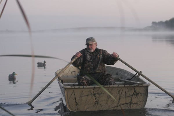 Sept. 24, 2011, near St. Peter, MN. Tracy Glass of St. Peter rows out to retrieve a duck he dropped during Minnesota's duck opener.