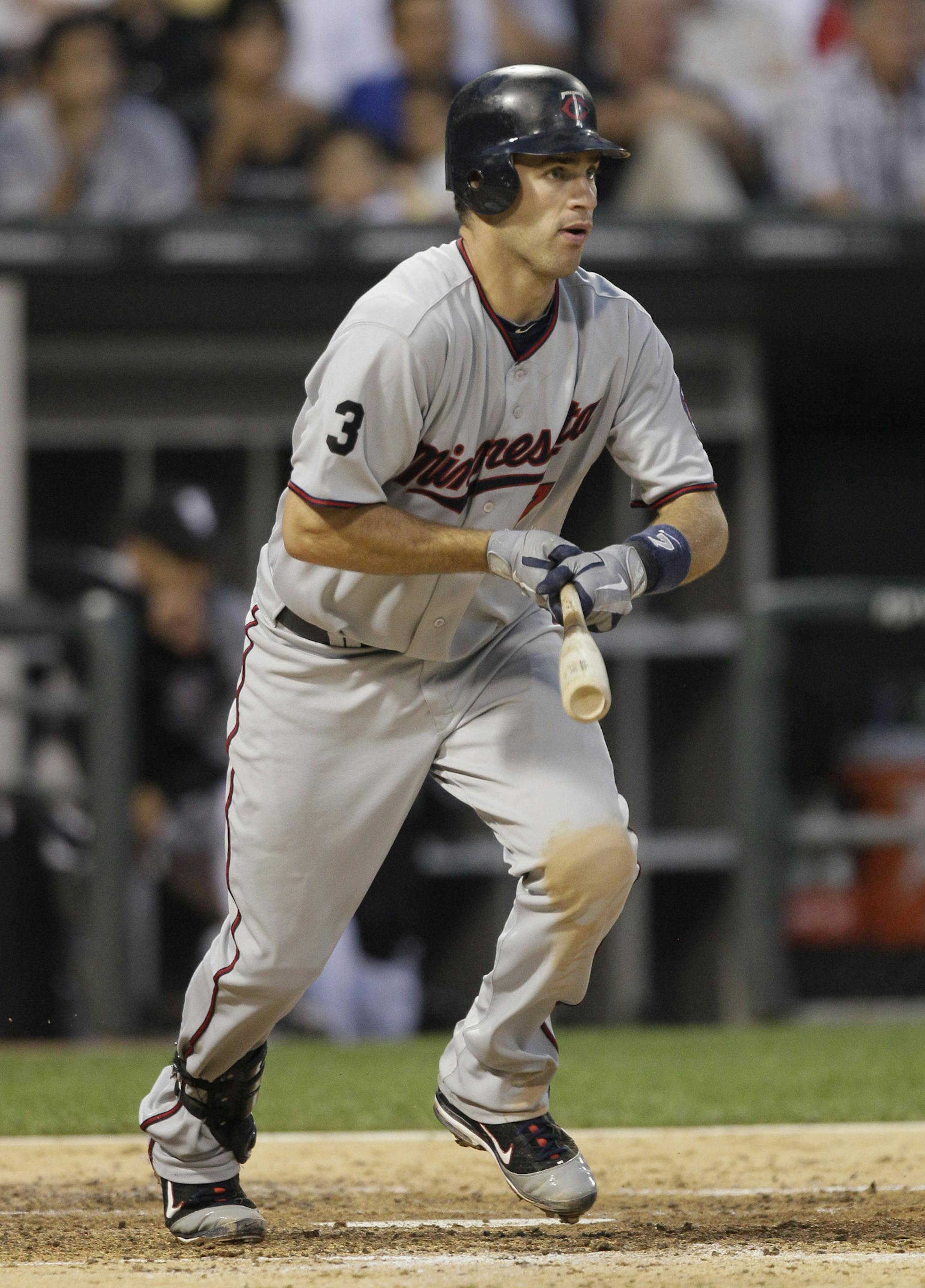 Minnesota Twins' Joe Mauer watches his single during the fourth inning of a baseball game against the Chicago White Sox, Thursday, July 7, 2011, in Chicago. (AP Photo/Nam Y. Huh) ORG XMIT: CXS118