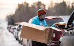 Andrea Orest, the statewide health improvement partnership coordinator, walked along a line of cars in Grand Marais, Minn. to hand out free at-home CO