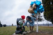 Baky Mikaele laid flowers on her son Jin Taylor’s grave at a primarily Hmong cemetery in Chisago City on Dec. 16, 2023. Jin, Mikaele’s only child,