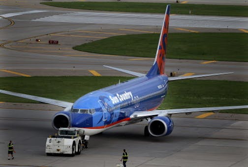 A Sun Country airplane was being prepared for take off early Friday, July 22, 2011, at the Humphrey terminal in Bloomington, MN.] (ELIZABETH FLORES/STAR TRIBUNE)