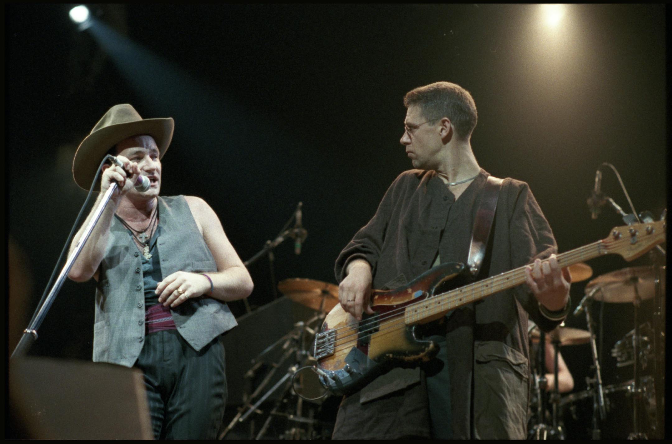 A file photo showing U2's Bono and Adam Clayton on the "Joshua Tree" tour at the St. Paul Civic Center in 1987.