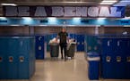 Connor Bayerkohler emptied trash and recycling bins in the commons area at Blaine High School on Thursday. Blaine High School has hired students after