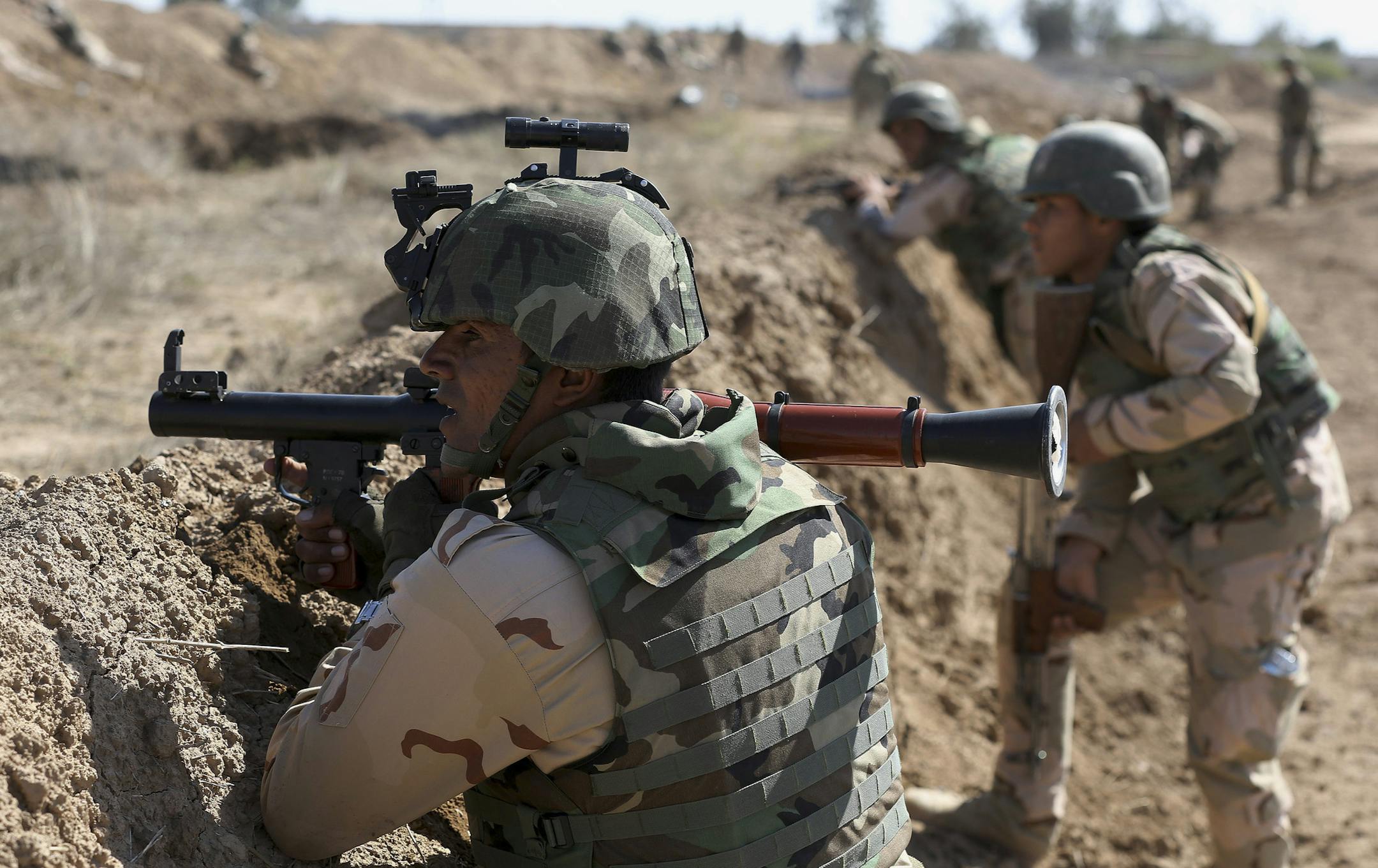 Iraqi security forces participate in a drill as U.S. forces train them in Taji, north of Baghdad, Iraq, Saturday, March 21, 2015. U.S. military officials have said a coordinated military mission to retake Mosul, Iraq's second largest city held by the Islamic State group, will likely begin in April or May and involve up to 25,000 Iraqi troops. But the Americans have cautioned that if the Iraqis are not ready, the offensive could be delayed. Iraqi officials have backed away from setting a timeline