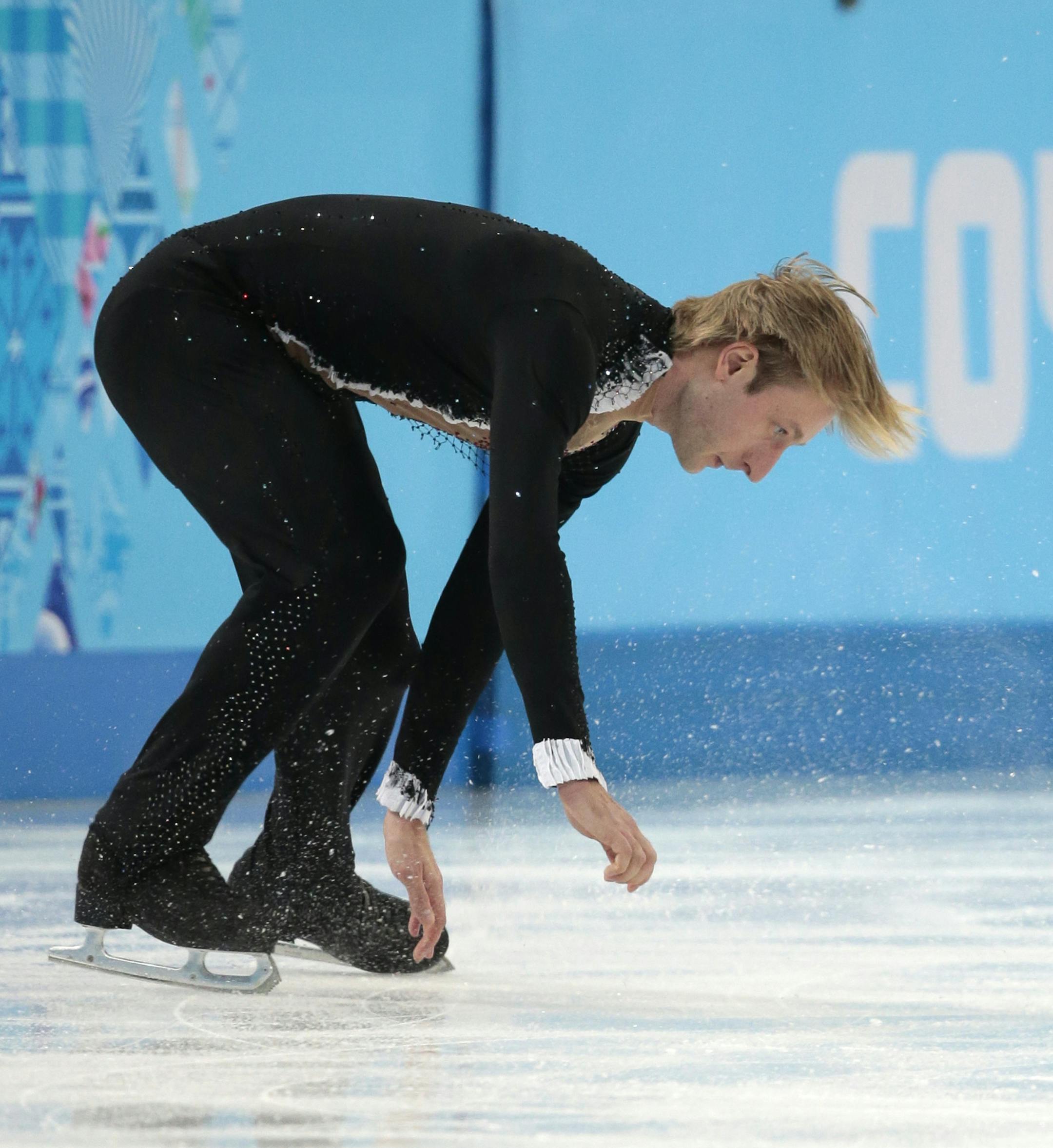 Evgeni Plushenko of Russia skates on the ice prior to pulling out of the men's short program figure skating competition due to illness at the Iceberg Skating Palace during the 2014 Winter Olympics, Thursday, Feb. 13, 2014, in Sochi, Russia. (AP Photo/Ivan Sekretarev)