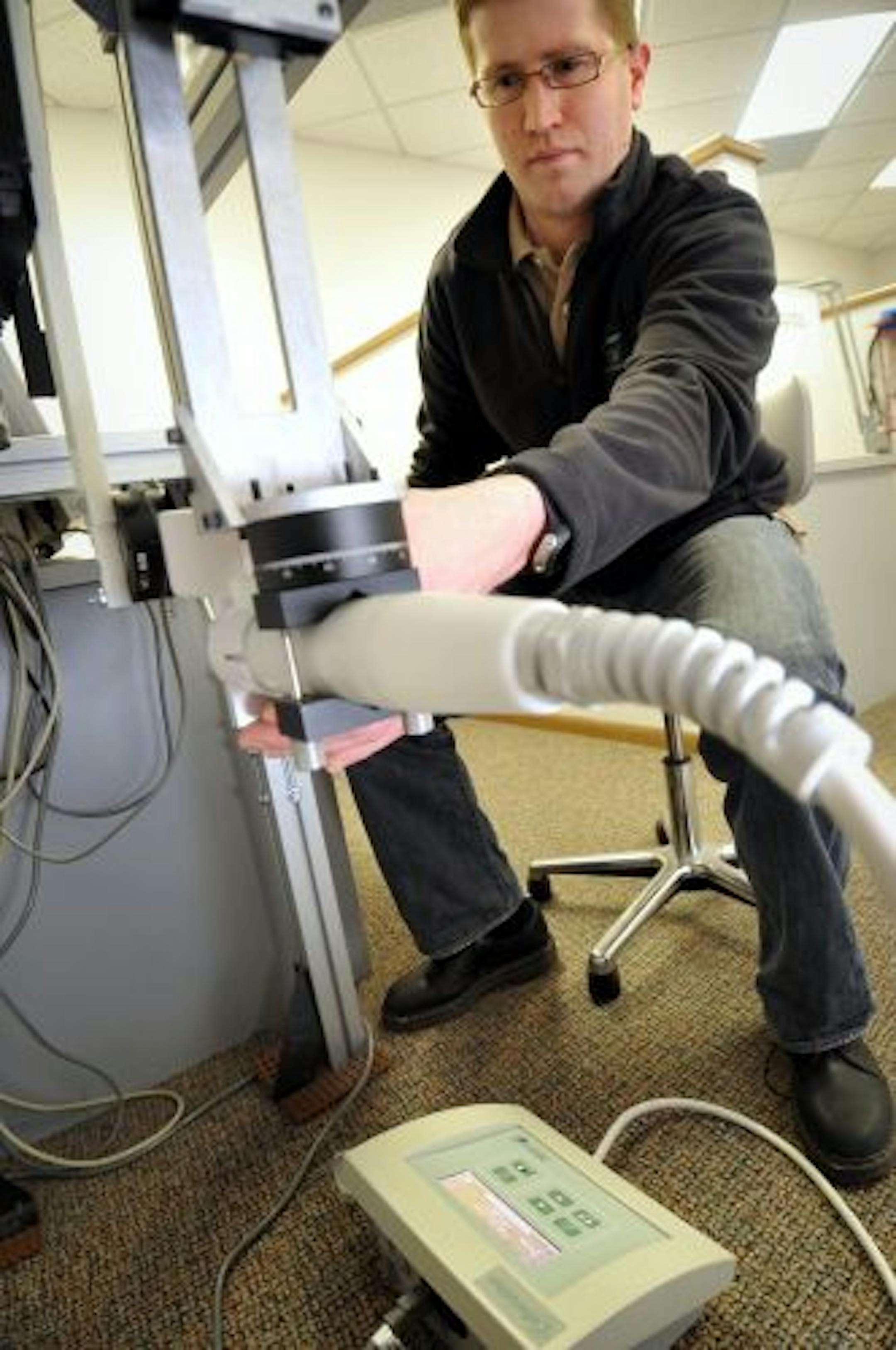 Ryan Tetzloff tested a Celleraton Mist Therapy System at the company's Eden Prairie headquarters. Celleration, which is developing this device that uses ultrasound energy coated in a mist to treat hard to heal wounds like ulcers and burns, is struggling to convince insurance companies to pay for the therapy.
