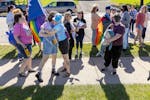Myrtle Lemon-Todd, in blue tie-dye, hugs attendees of a rally in support of a transgender Hopkins High School junior who allegedly was assaulted leavi