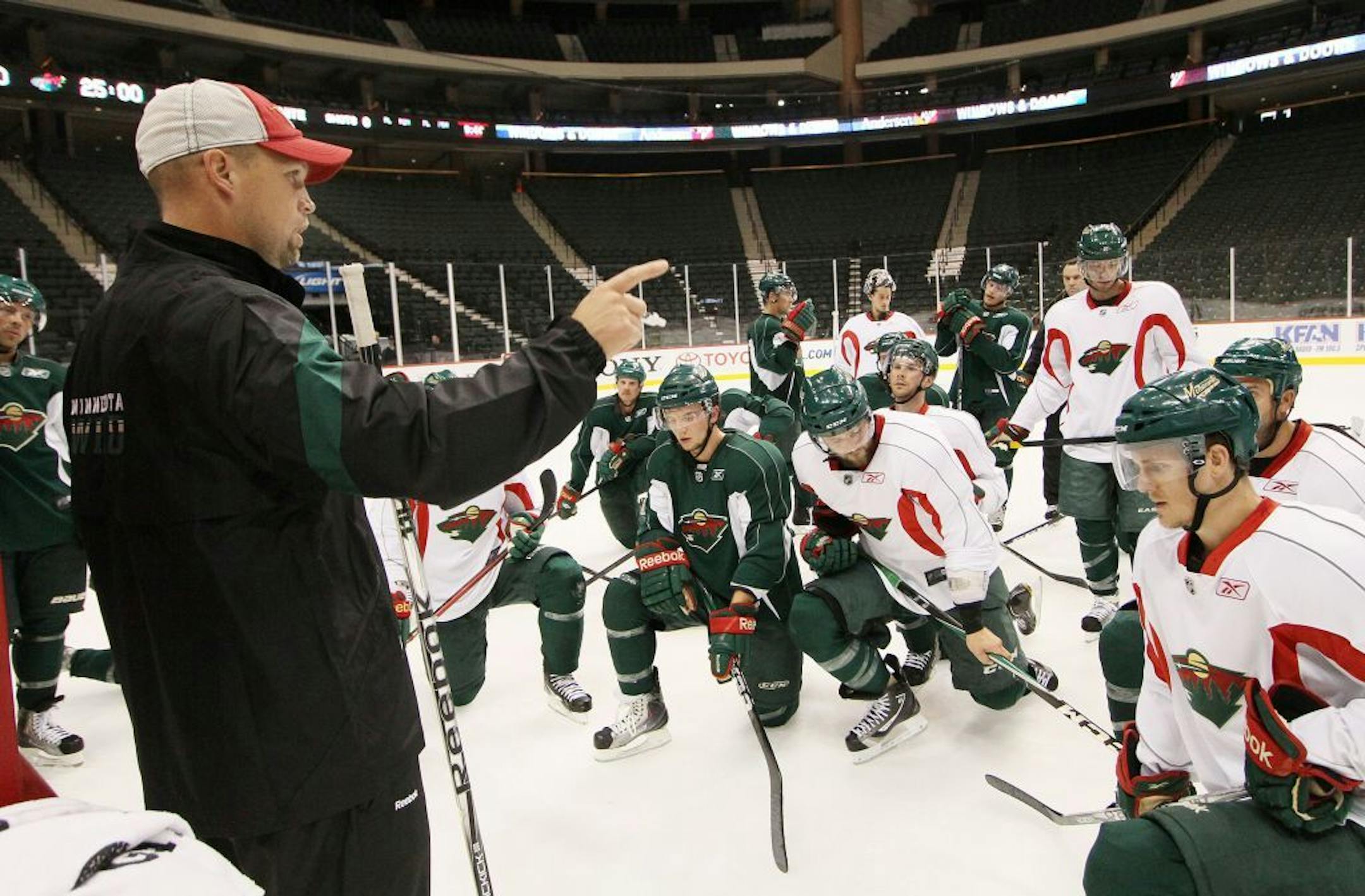Minnesota Wild head coach Mike Yeo, left, directs his team during NHL hockey training camp Saturday, Sept. 17, 2011, in St. Paul, Minn.