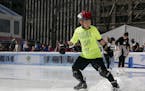 A skater kicks up water while trying to stop in a puddle at an outdoor ice rink in New York, Wednesday, Feb. 21, 2018. (AP Photo/Seth Wenig)